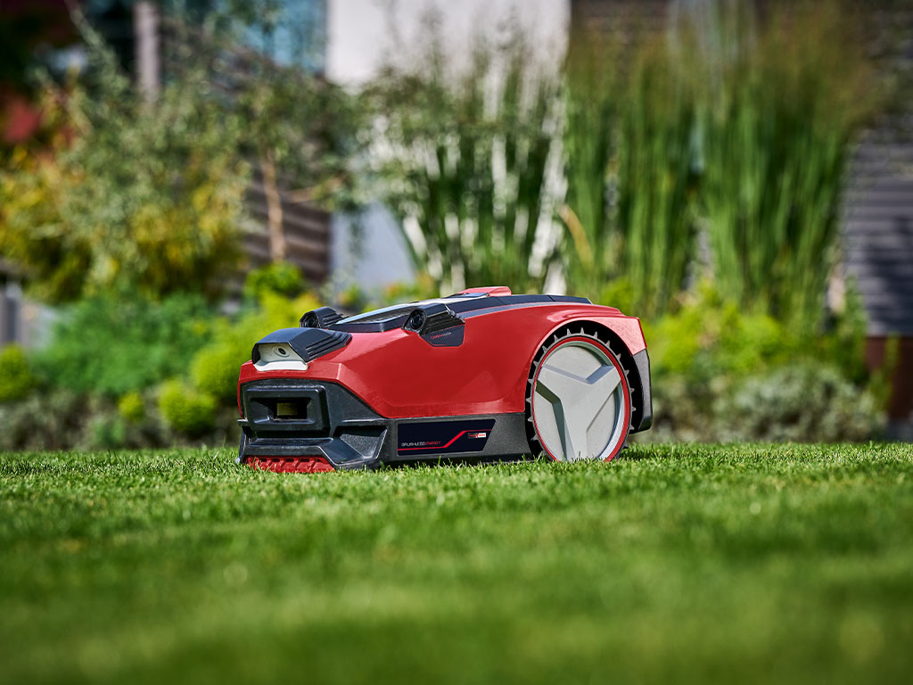 Einhell robotic lawnmower on a healthy, green lawn in the garden
