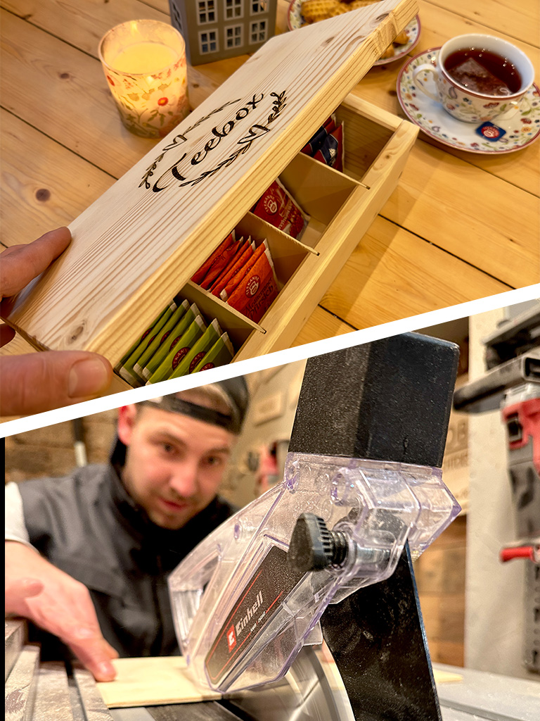 Handmade wooden tea box with engraved “tea box” lid, filled with tea bags, placed on a wooden table next to a cup of tea and candle.