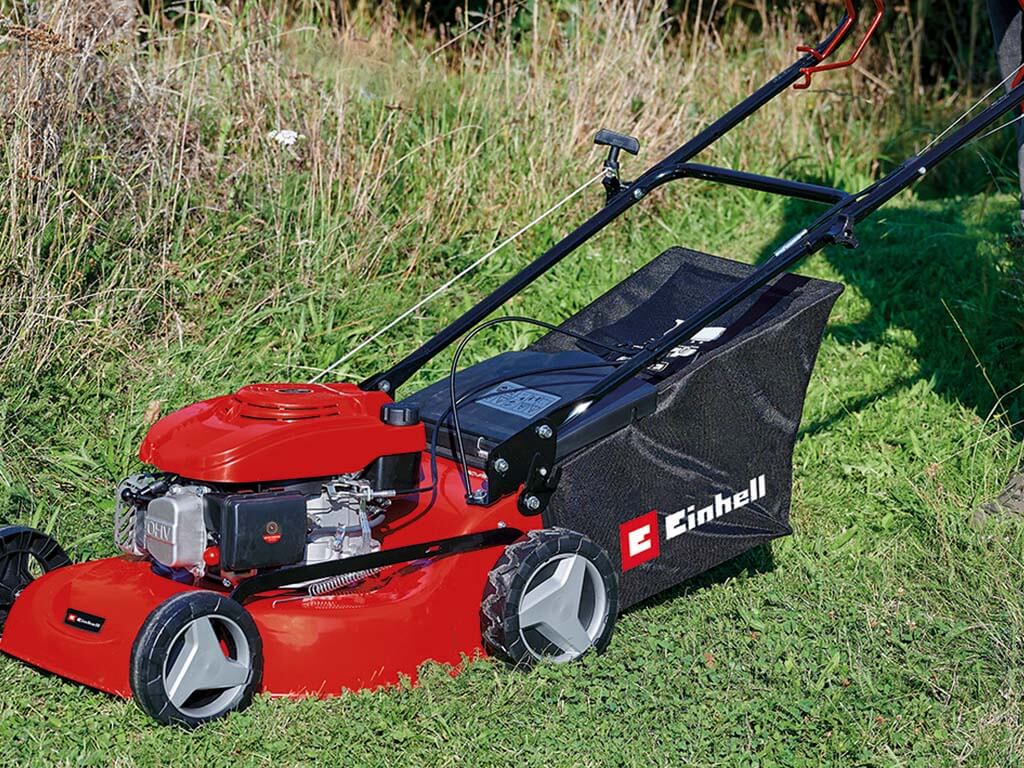 einhell lawn mower in the middle of the tall grass