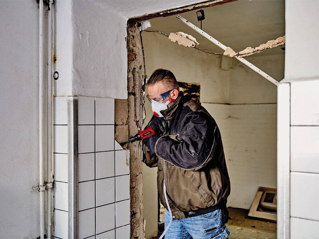 a man removes flow from the wall