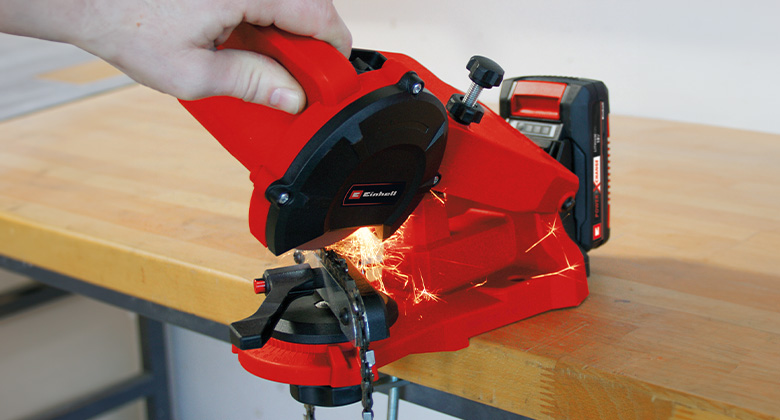 jemand schärft eine Sägekette mit dem Einhell Akku-Sägekettenschärfgerät