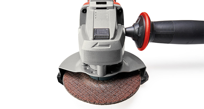 Close-up of the angle grinder head with mounted grinding disc.