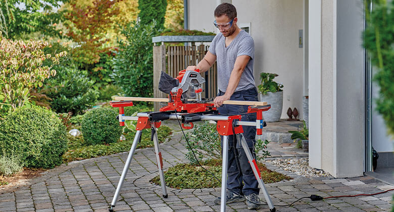 man working with a cross cut mitre saw